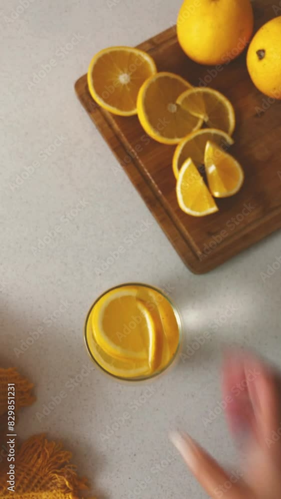 Woman waling with an orange drink Woman waling with an orange drink