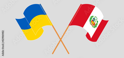 Crossed and waving flags of Ukraine and Peru