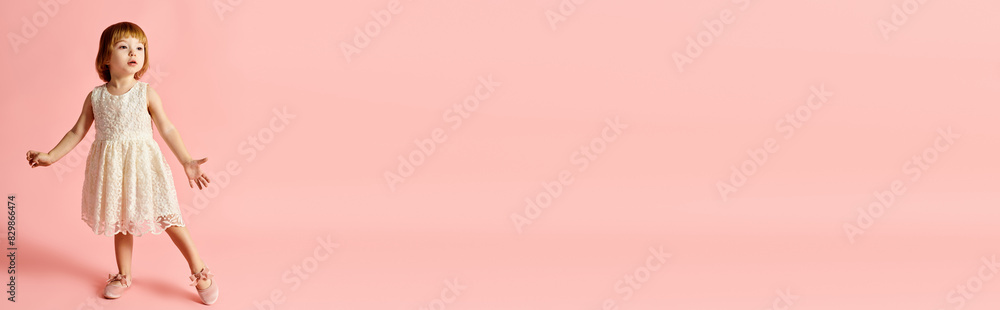 Cute girl in white dress charmingly poses against vibrant pink backdrop. Cute girl in white dress charmingly poses against vibrant pink backdrop.