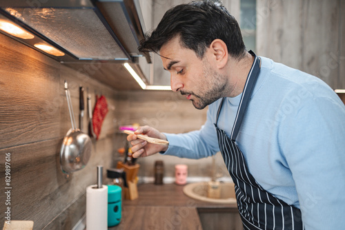 Man Standing in Kitchen Preparing Food