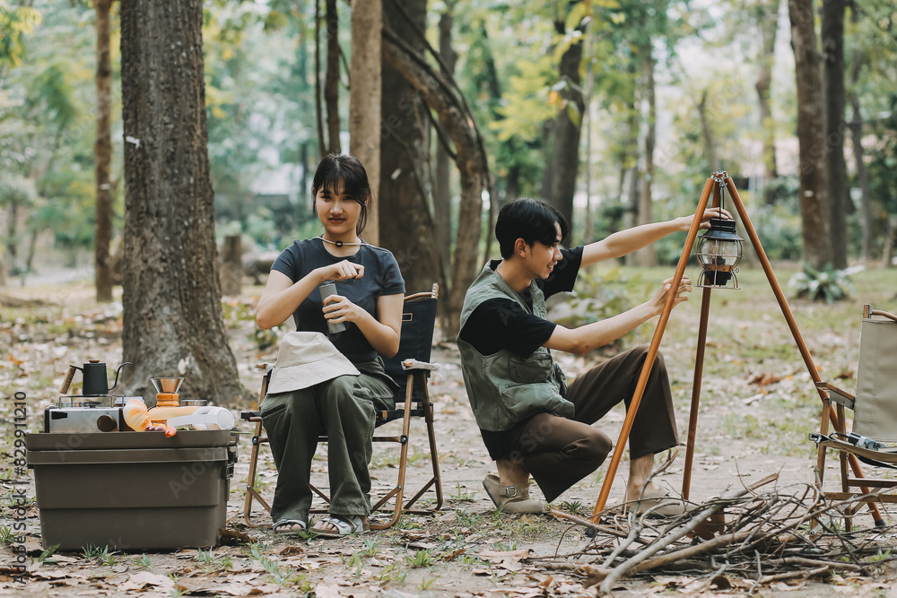 Asian couple sweet in tent inside on they camping trip, traveller relax and sleep togather in out door and camping trip