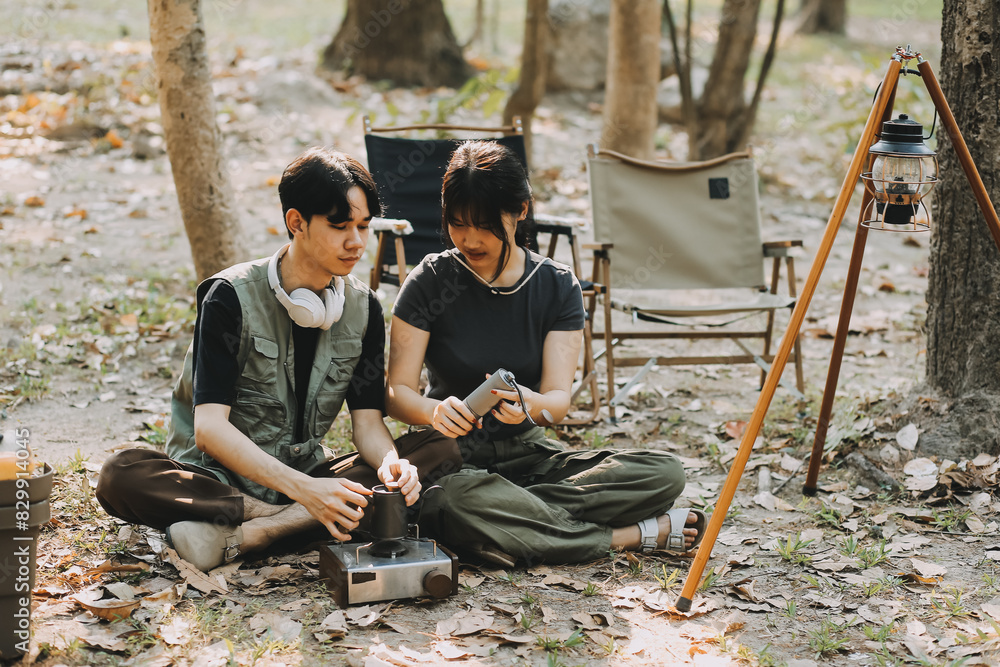 Asian couple sweet in tent inside on they camping trip, traveller relax and sleep togather in out door and camping trip Asian couple sweet in tent inside on they camping trip, traveller relax and sleep togather in out door and camping trip