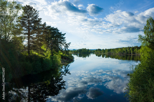 Calm lake reflecting clouds in sky  V  rmlands wilderness area in Sweden  Nature of Scandinavia