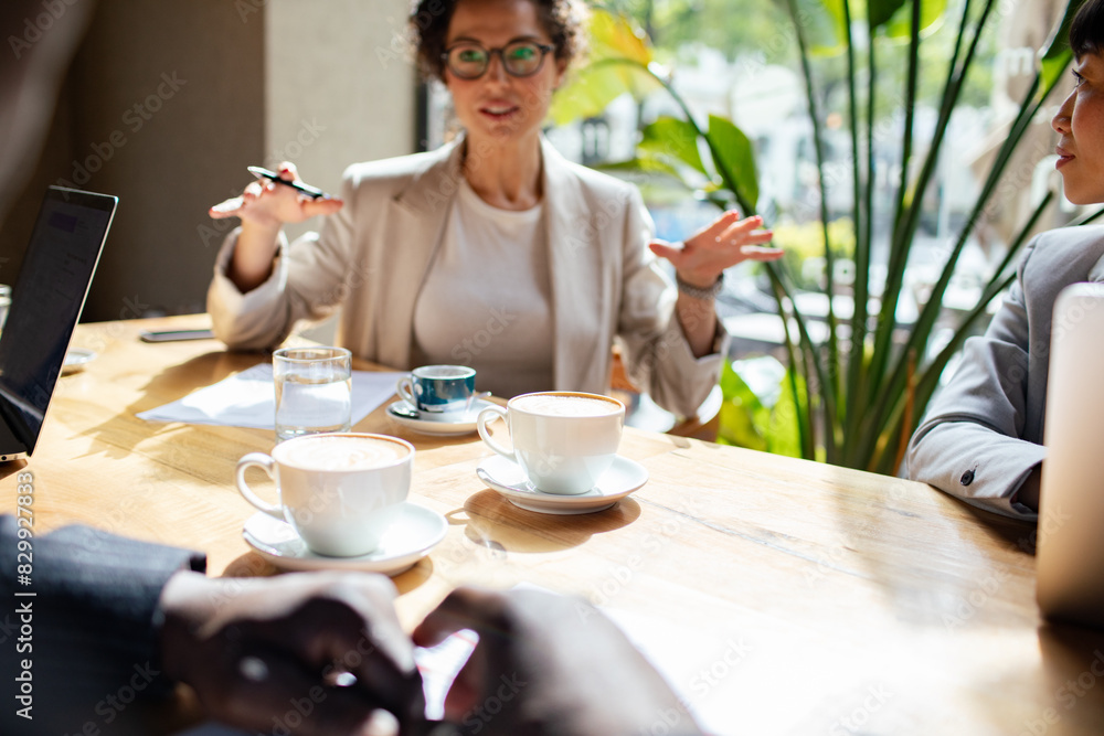 Business meeting in a cafe with diverse professionals Business meeting in a cafe with diverse professionals