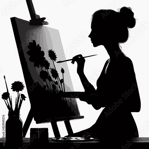 Creative Serenity: A Backlit Silhouette of a Woman Painting Floral Art on an Easel, Capturing the Artistic Atmosphere and Delicate Brushstroke Details in Black and White