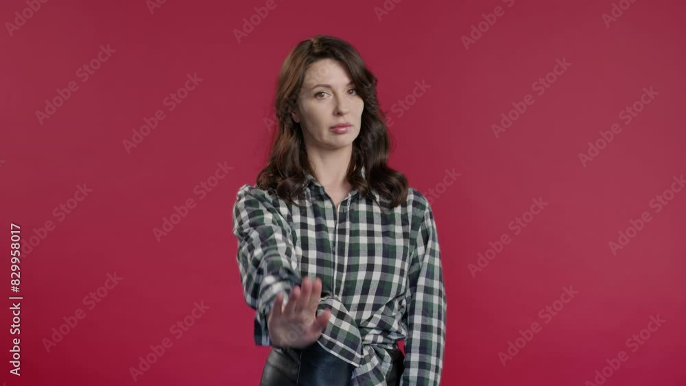 Uninterested woman disapproving with NO sign gesture. Denying, rejecting, enough Uninterested woman disapproving with NO sign gesture. Denying, rejecting, enough