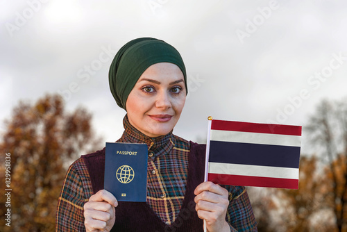 Muslim Woman Holding Passport and Flag of Thailand
