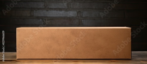 A brown paper box with a textured surface in the background providing ample copy space for an image