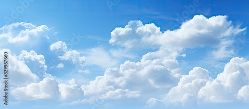 Descriptive blue sky with clouds forming an abstract background catering to copy space image