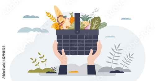 Food drive as grocery donation for poor community tiny person hands concept, transparent background. Full basket with healthy products for eating illustration. Volunteer giving ingredients.