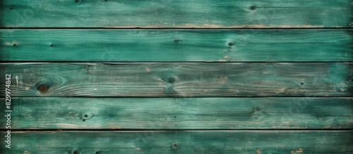 An old vintage green wooden fence serves as a close up copy space image with textured wall panels or floor planks providing a natural and abstract background for text