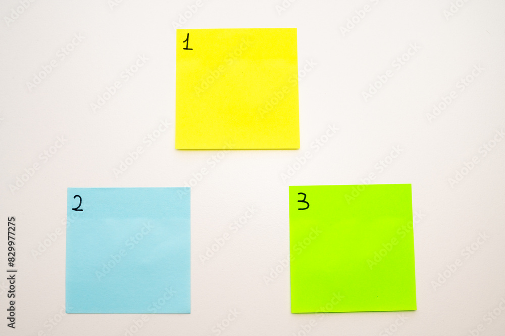 Background with colored sticker sheets, numbered from one to three. First second Third. 