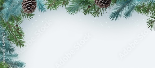 A festive frame template for Christmas with green and blue fir branches set against a serene grey background ideal for displaying a copy space image