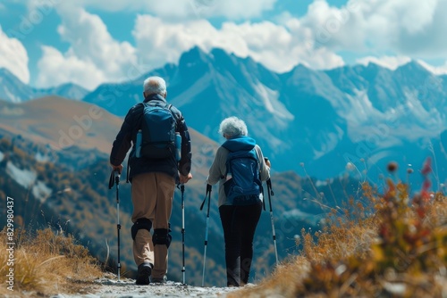 Elderly Couple Hiking in the Mountains with Trekking Poles and Knee Supports for Leg Pain Management