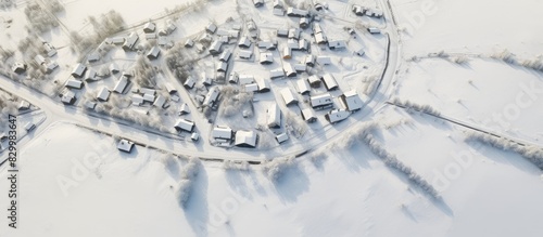 Aerial view of a snowy village during winter with plenty of empty space for adding images or text. with copy space image. Place for adding text or design © vxnaghiyev