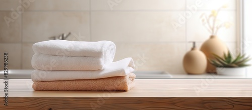 Blurred bathroom background with a wood plate holding towels for product display Ample space for image placement