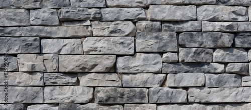 A wall made of gray granite with ample space to include an image or text