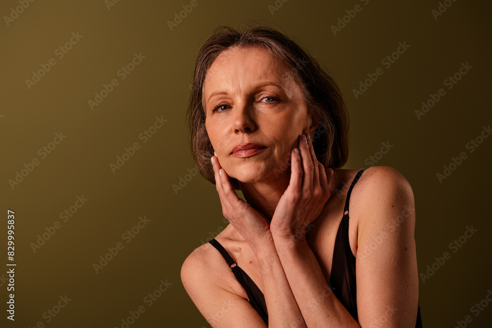 Photo of gorgeous retired female touch soft face dressed black lingerie brown background no retouch self acceptance Photo of gorgeous retired female touch soft face dressed black lingerie brown background no retouch self acceptance