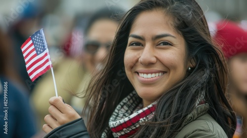 Happy smiling Female immigrant holding a small US flag the day of her naturalization ceremony. S photo