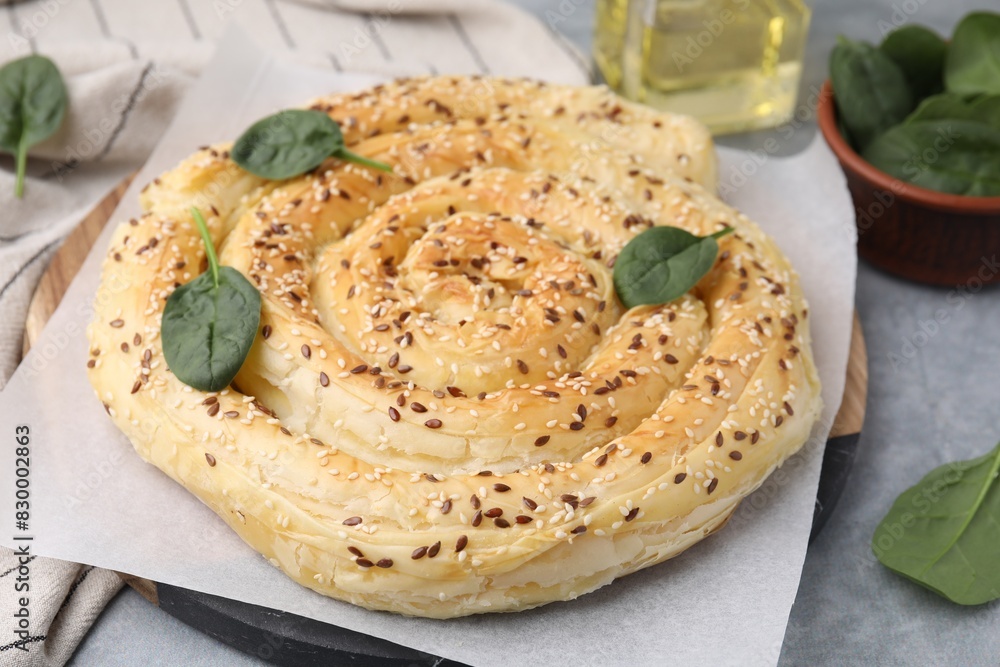 Delicious puff pastry with spinach on grey table, closeup Delicious puff pastry with spinach on grey table, closeup