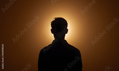 silhouette of a person on orange light, black person incognito shape