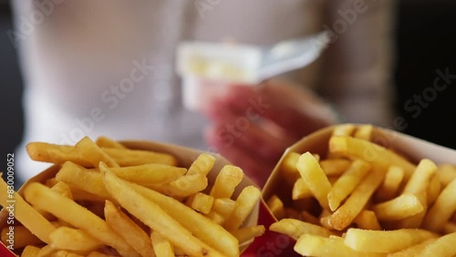 Girl Consuming French Fries With Dip In A Fast Food Joint