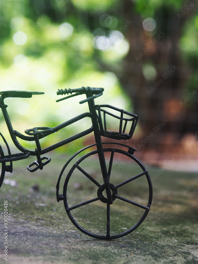 bicycle model toy decorate in green garden and bokeh background bicycle model toy decorate in green garden and bokeh background