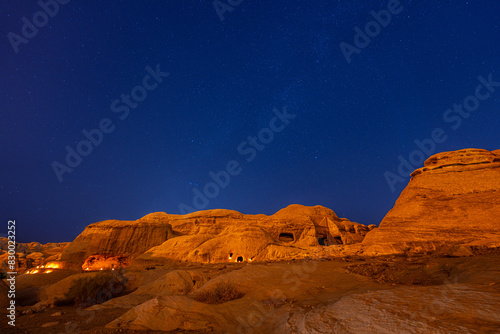 Enchanting Night View of Petra, Jordan - Illuminated Ancient Ruins and Majestic Desert Landscape Under Starry Sky