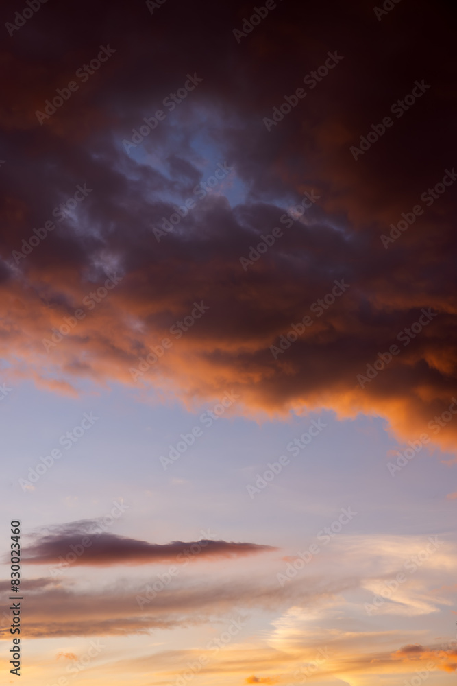 Fototapeta premium Dramatic sky with orange and dark clouds
