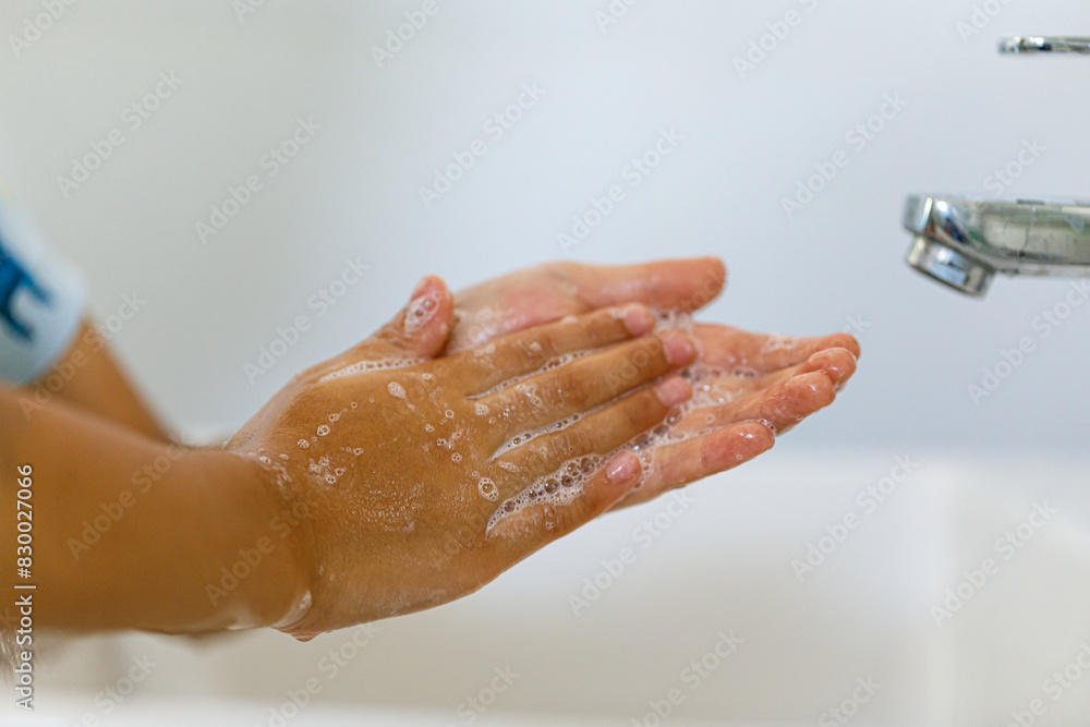 close up hands of children washing hands with soap under the faucet with water,copy space for text or product you. clean and Hygiene concept. close up hands of children washing hands with soap under the faucet with water,copy space for text or product you. clean and Hygiene concept.