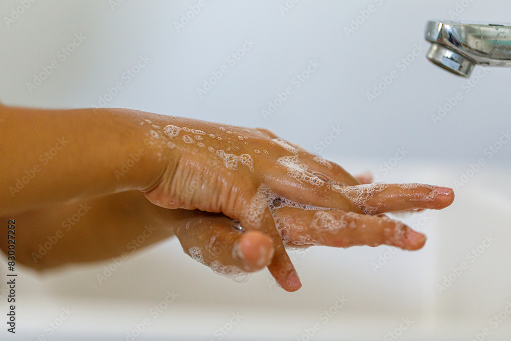 Fototapeta premium close up hands of children washing hands with soap under the faucet with water,copy space for text or product you. clean and Hygiene concept.