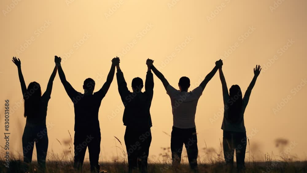 Silhouette people holding hands. Group united at sunset. Celebrating success freedom together. Bonding in nature. Teamwork and unity outdoors. People enjoying moment freedom. People success freedom. Silhouette people holding hands. Group united at sunset. Celebrating success freedom together. Bonding in nature. Teamwork and unity outdoors. People enjoying moment freedom. People success freedom.