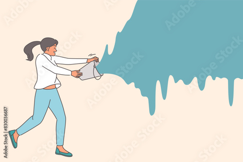 Woman pours bucket of paint onto wall, wanting to express creativity or repaint surface