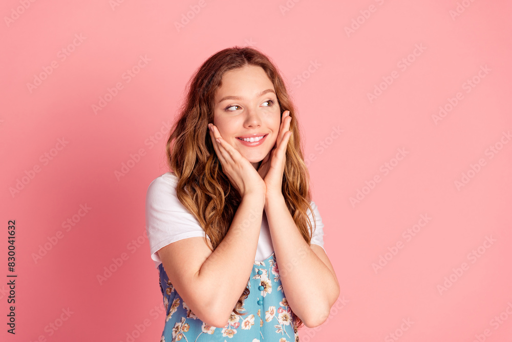 Portrait of lovely young girl look empty space wear dress isolated on pink color background Portrait of lovely young girl look empty space wear dress isolated on pink color background