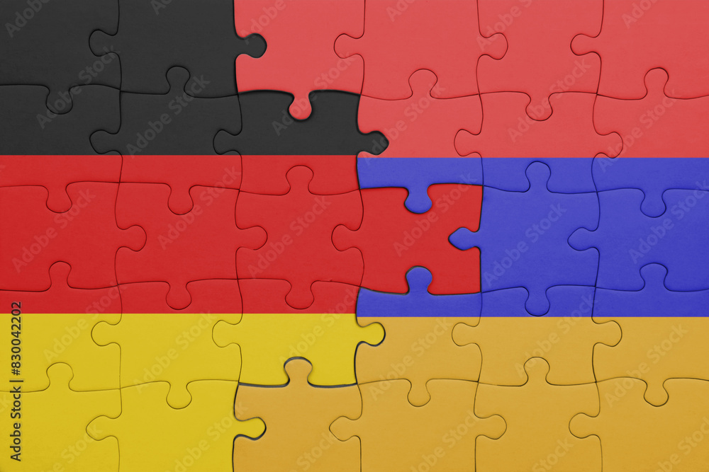 puzzle with the colourful national flag of armenia and flag of germany. puzzle with the colourful national flag of armenia and flag of germany.