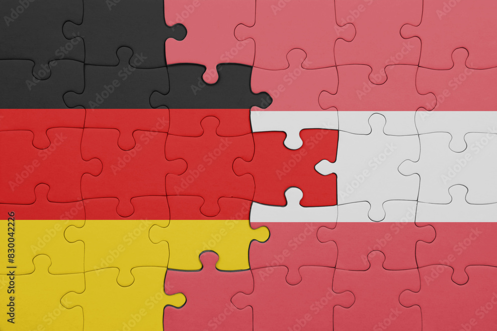 puzzle with the colourful national flag of austria and flag of germany. puzzle with the colourful national flag of austria and flag of germany.