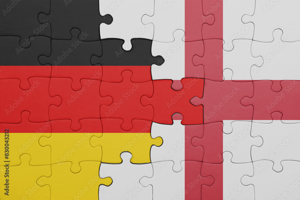 puzzle with the colourful national flag of england and flag of germany. puzzle with the colourful national flag of england and flag of germany.