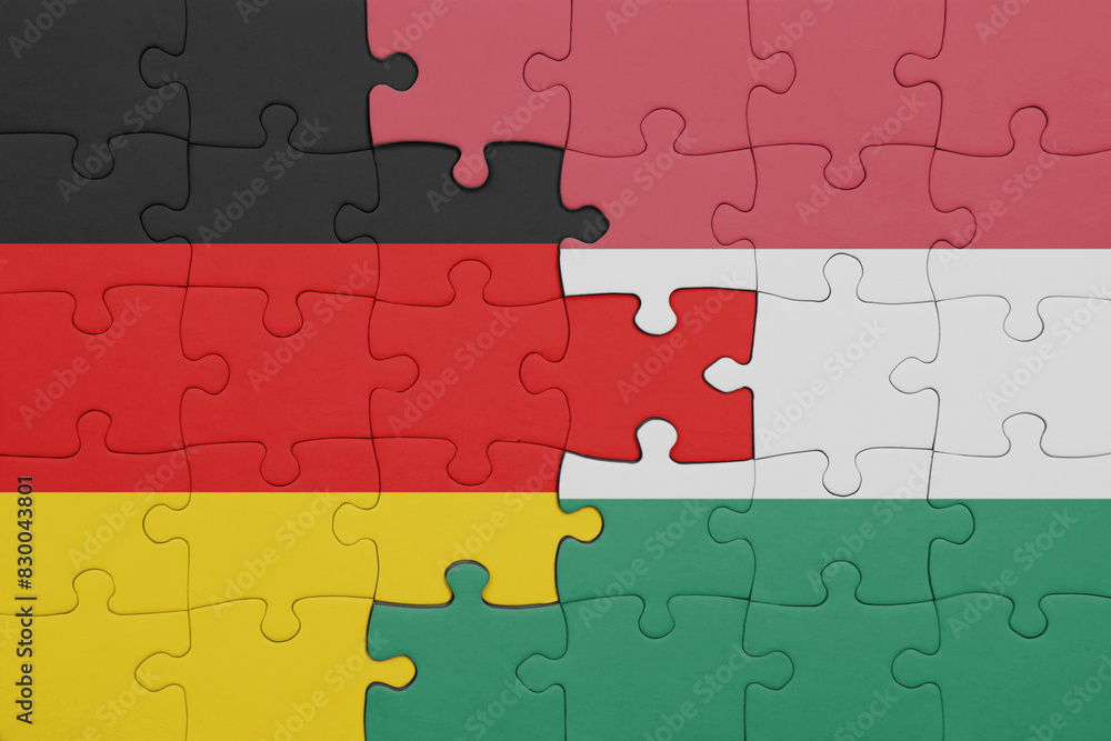 puzzle with the colourful national flag of hungary and flag of germany. puzzle with the colourful national flag of hungary and flag of germany.