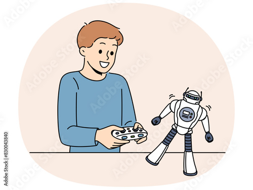 Boy with toy remote controlled robot for concept of learning robotics. Schoolboy is passionate about playing with robot and dreams of becoming engineer or creating cyborgs with artificial intelligence