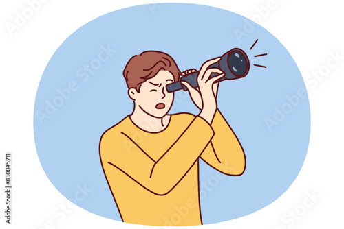 Shocked guy is looking through spyglass while looking at sights or watching rare astronomical phenomenon. Surprised man spying on neighbors using spyglass for uncoordinated surveillance