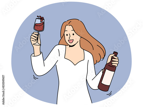 Woman dances at party holding bottle of wine and glass filled with exquisite alcoholic drink. Girl in white dress for party is addicted to alcohol and rejoices at new opportunity to drink
