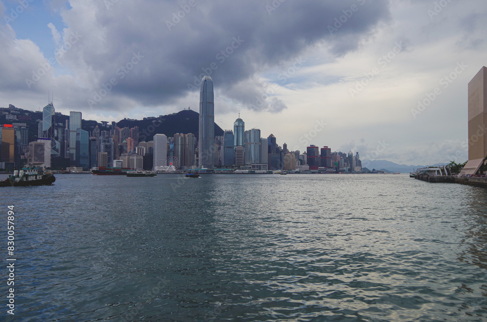 Fototapeta premium Panoramic skyline silhouette view of Hongkong Hong Kong Victoria Harbor and port infrastructure bay scenic landscape seascape scenery during twilight blue hour in China
