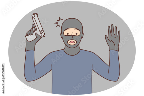 Male robber with gun raise hands up