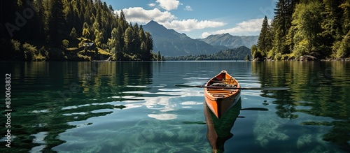 landscape photo of Man with canoe on lake