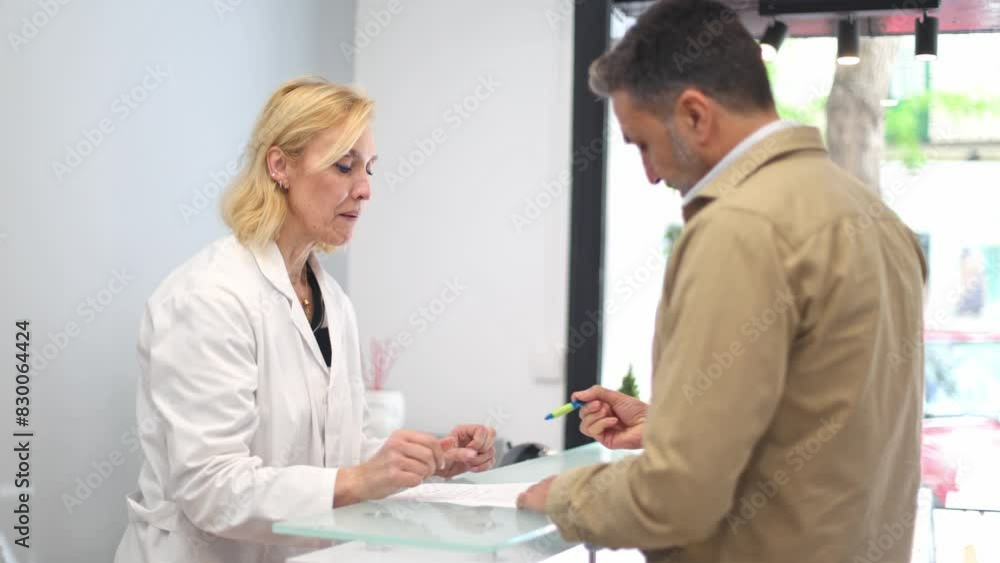 Doctor and patient discussing treatment details at a beauty clinic's reception. Doctor and patient discussing treatment details at a beauty clinic's reception.