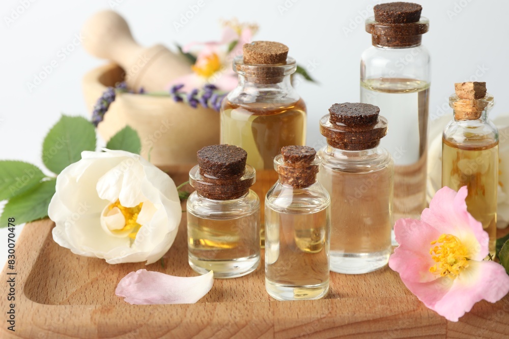Aromatherapy. Different essential oils, flowers and green leaves on table Aromatherapy. Different essential oils, flowers and green leaves on table