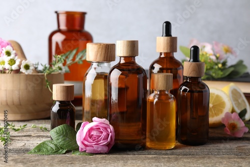 Wallpaper Mural Aromatherapy. Different essential oils and flowers on wooden table Torontodigital.ca