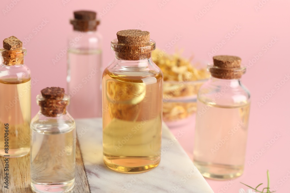 Aromatherapy. Different essential oils on pink background Aromatherapy. Different essential oils on pink background