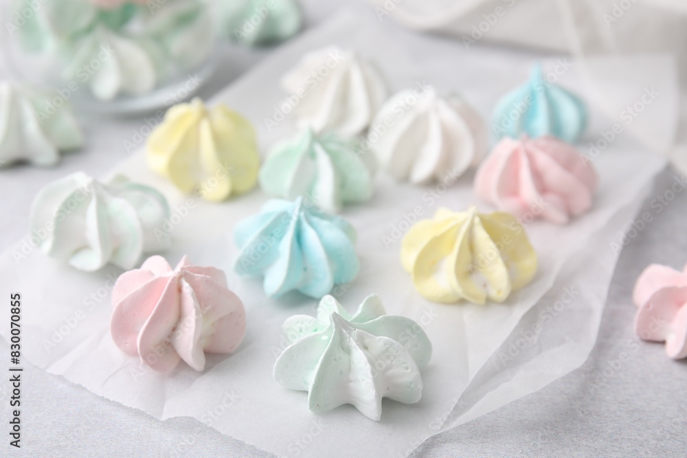 Tasty meringue cookies on light grey table, closeup Tasty meringue cookies on light grey table, closeup