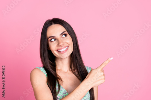 Photo of adorable cute woman wear trendy clothes look empty space isolated on pink color background